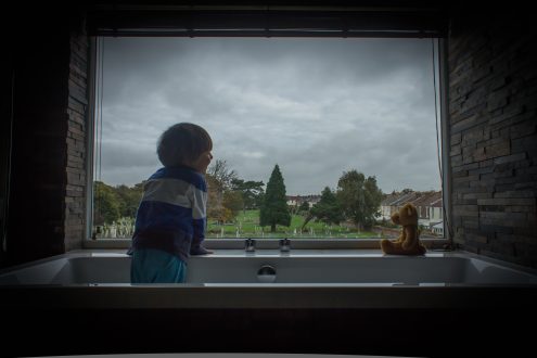 Little boy looking out of the window